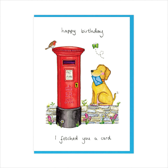 A square greeting card with a white front, bordered in blue. The card features a watercolor illustration of a red post box, a yellow dog wearing a blue bow tie, a small bird, flowers, and handwritten text reading 'happy birthday' and 'I fetched you a card'.